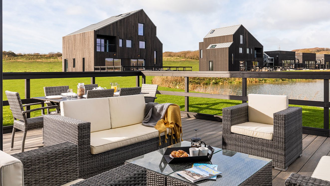 
              Exterior of barn area at Retallack Resort and Spa overlooking the lake and beautiful Cornish countryside.
              