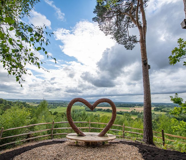 Our Sandy Balls holiday park. There is a wooden, heart-shaped bench that overlooks the holiday park.