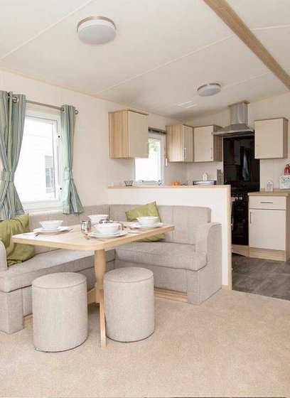 The living and dining area of our bright and spacious comfort static caravan. The perfect way to stay.