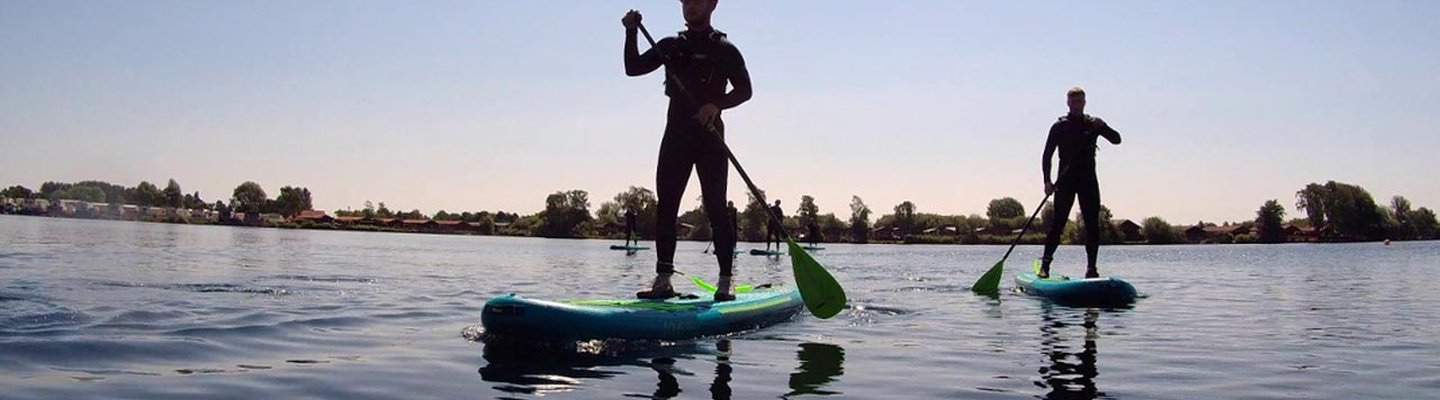 
          A photo of two people paddle boarding in the calm lake at our Tattershall Lakes holiday park.
          