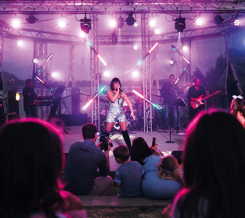A women performing live on stage.