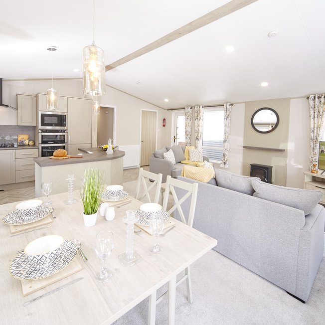 
                A bright and airy living and dining space with a contemporary finish to the interior decorating. Just one of many holiday home lodges for sale.
                