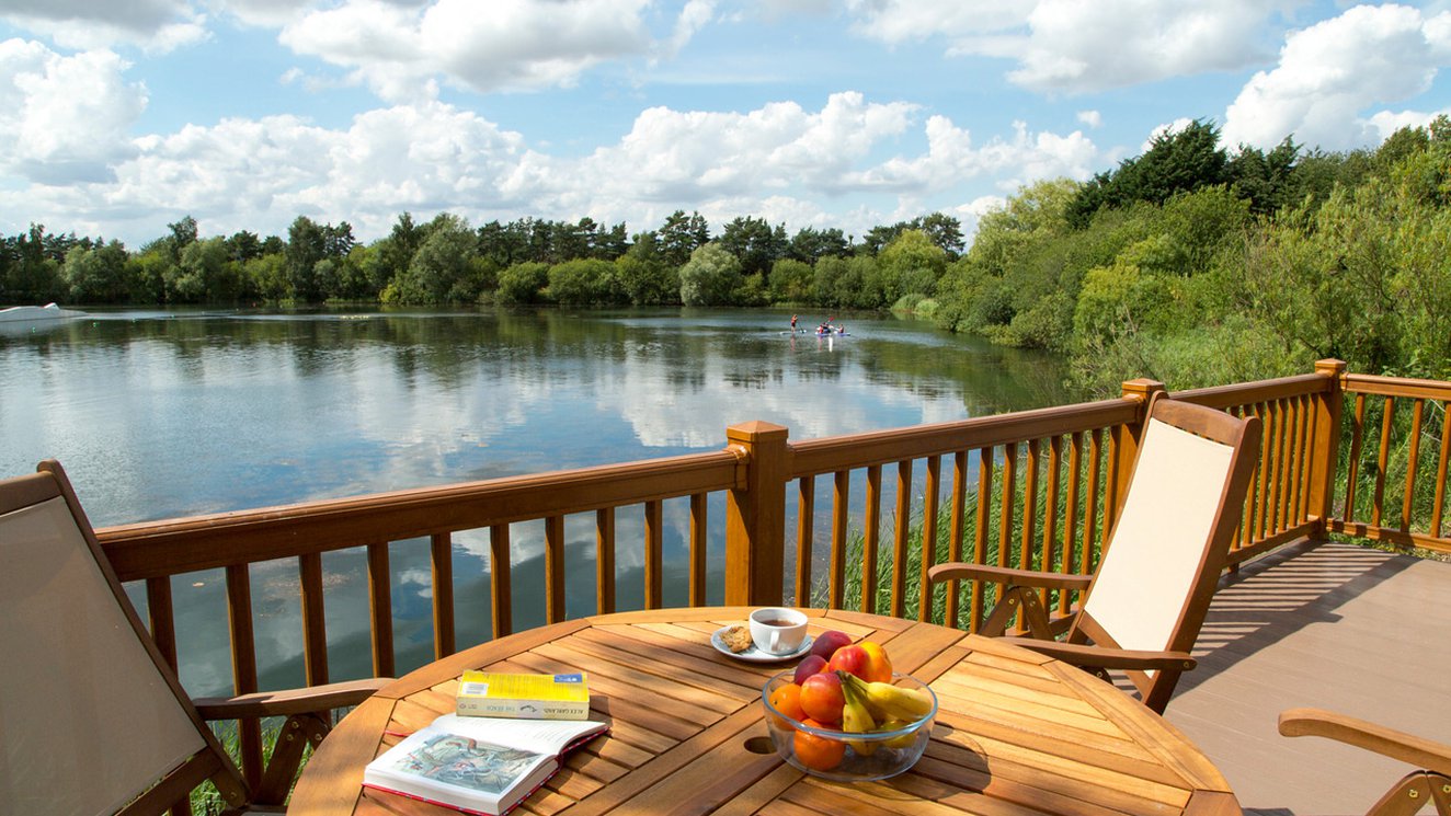 
              A view of the lake from one of our stunning lodges at Tattershall Lakes on a sunny day.
              