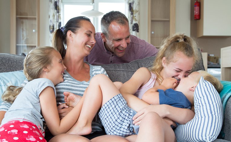 A young family enjoying themselves in one of our holiday homes. You too can experience summertime happiness with Away Resorts!