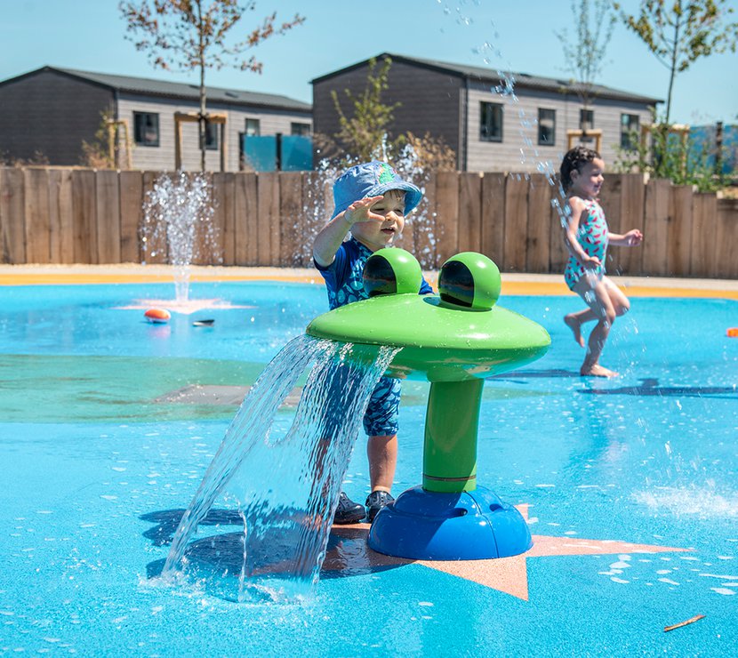 Young child enjoying the Mill Rythe splash pad.
