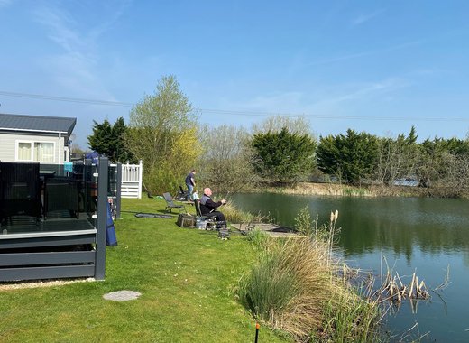 A couple of men fishing at our stunning lakeside resort, Tattershall Lakes.