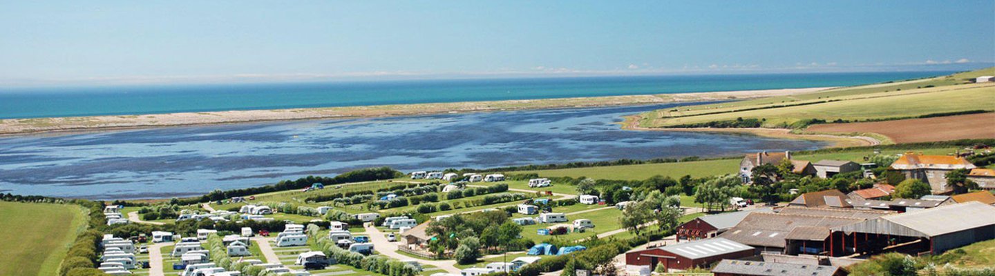
          A drone image of our camping and touring park in Dorset, East Fleet Farm with views of the lagoon.
          