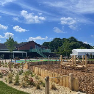 The playground area in our Appletree holiday park. The playground area contains climbing frames and large free spaces. The playground is empty.