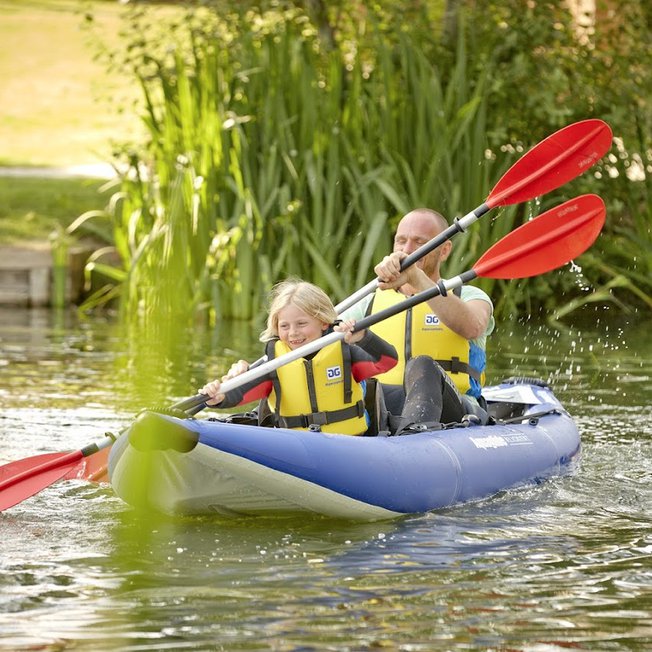 
                A man and child canoeing down the lake.
                