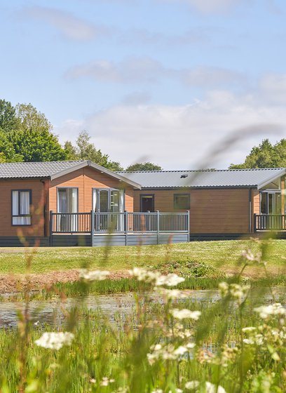 Over lake view of our lodges available to holiday at, Appletree Holiday Park.