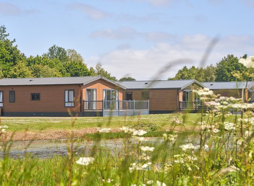Over lake view of our lodges available to holiday at, Appletree Holiday Park.