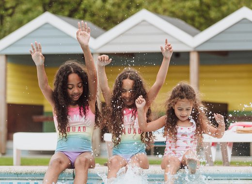 Girls playing in the outdoor pool at Newquay Bay Holiday Park.