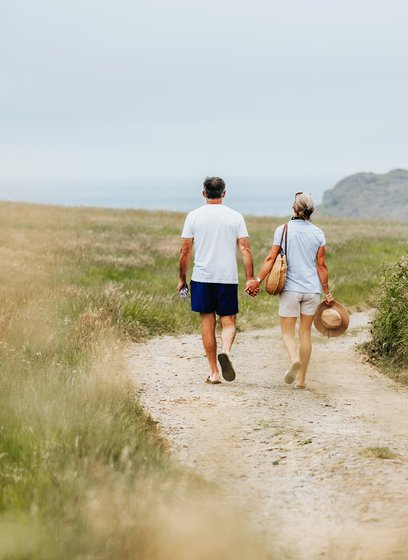 A happy couple walking hand in hand near one of our holiday parks.