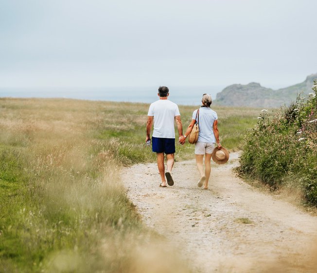 A happy couple walking hand in hand near one of our holiday parks.