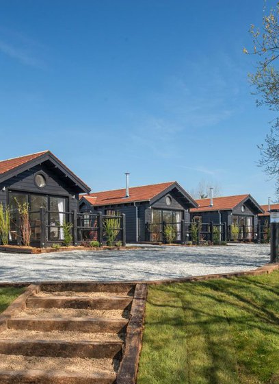 A row of holiday homes at The Lakes Rookley, Isle of Wight, on a sunny day. Explore our stunning accommodation options.