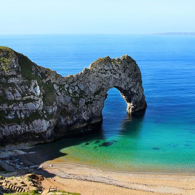 
                A image of Durdle Door on a sunny day.
                
