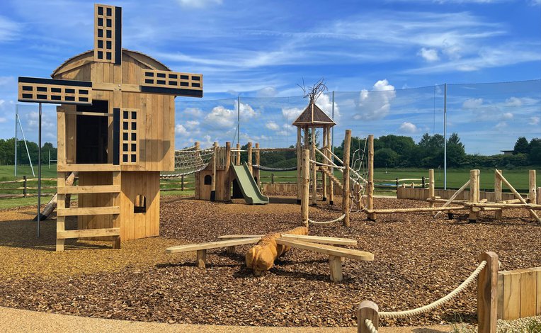 A photo of an outdoor wooden playground.