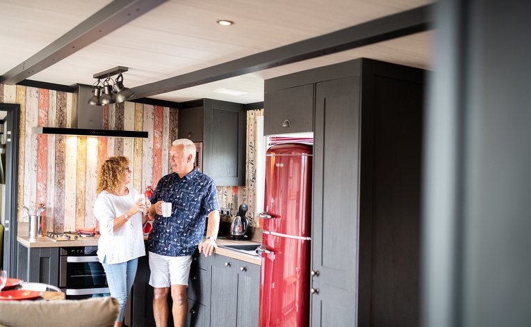 Couple enjoying their holiday home at Mill Rythe Holiday Park, Hampshire.