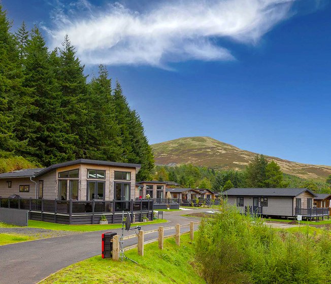 Our Glendevon holiday park. There are many luxury lodges in the area, with large hills and woodland surrounding the park.
