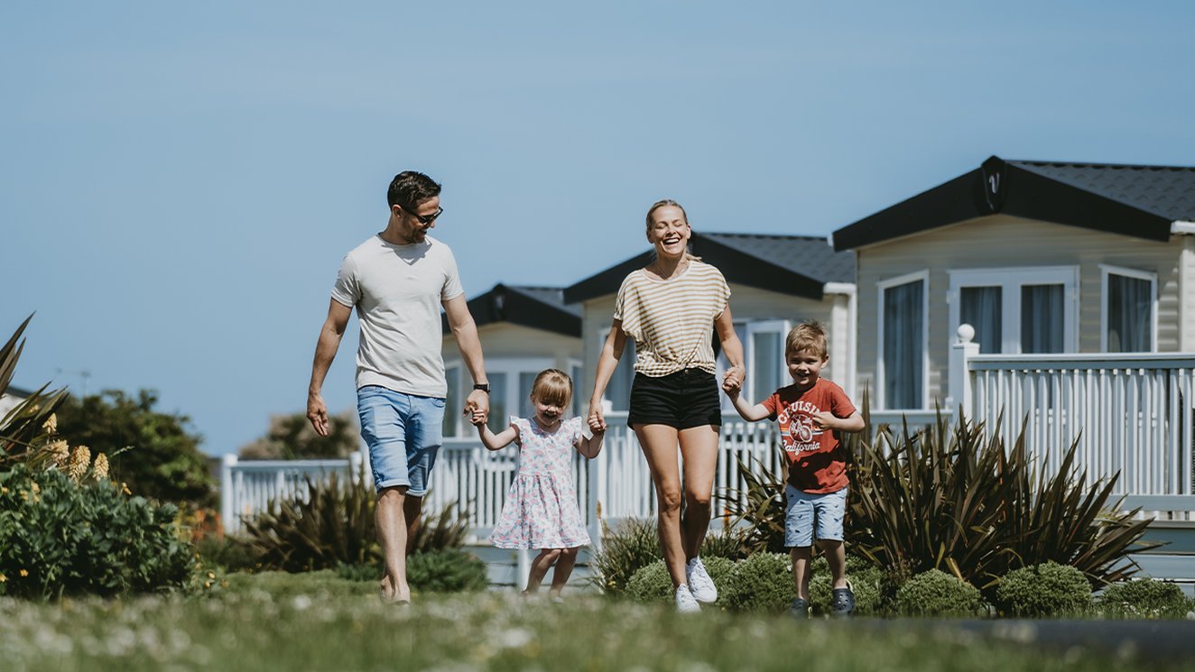 
              Family walking through our Newquay Bay Holiday Park.
              