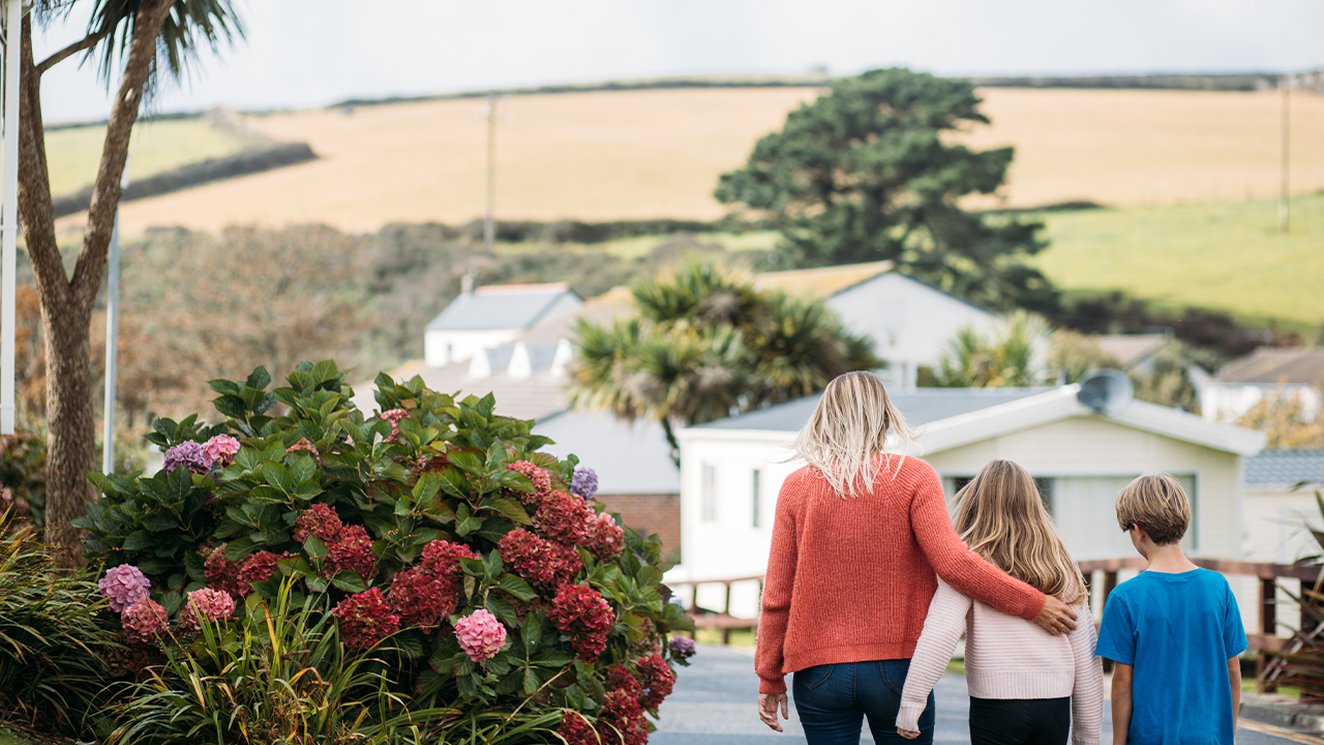 
              Family walking through Newquay Bay Holiday Park.
              