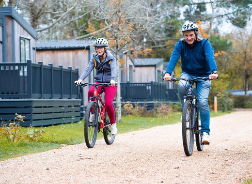 An image of two people cycling through on of our parks together.
