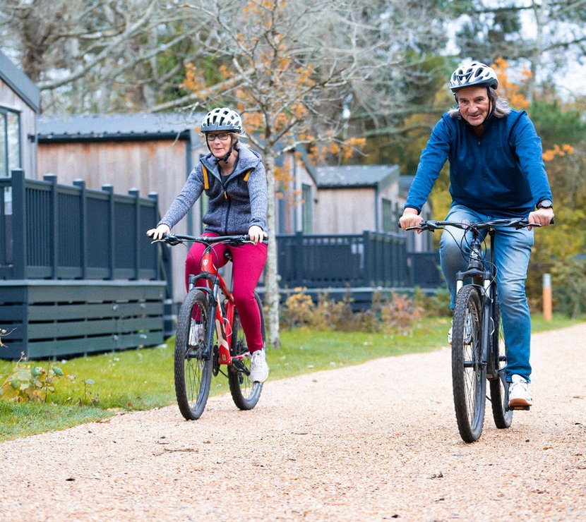 An image of two people cycling through on of our parks together.
