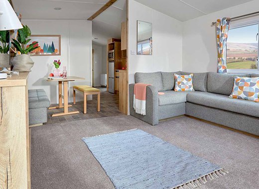 The bright and spacious lounge area of one of our Comfort Caravans at The Lakes Rookley.