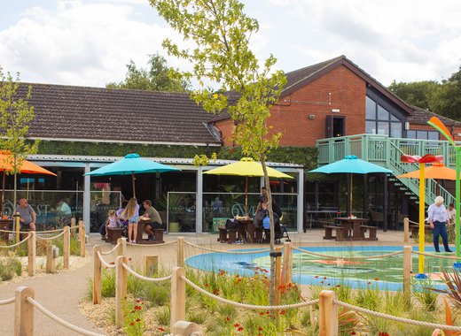 The outdoor area at our holiday park in Lincolnshire, Appletree. There is a few of the restaurant and the outdoor splash pad.
