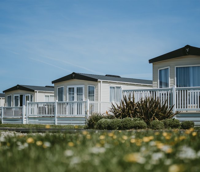 A row of caravans on a summers day at our stunning Cornish park, Newperran.