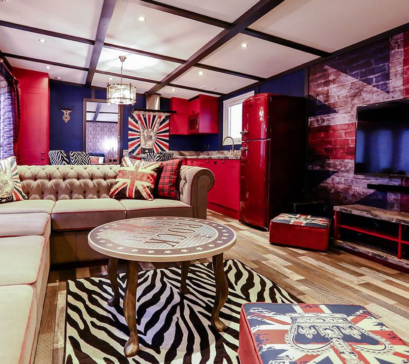 The lounge in our Rockstar holiday home. There’s a spacious kitchen, a large TV and sofa, and a theme of red, white, and blue Great British colours.