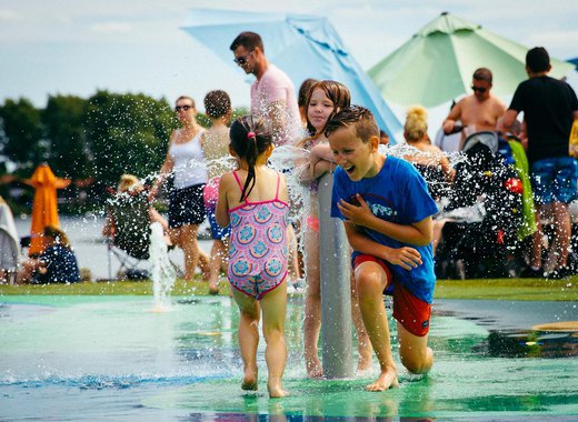Young children playing in our outdoor splash pad.