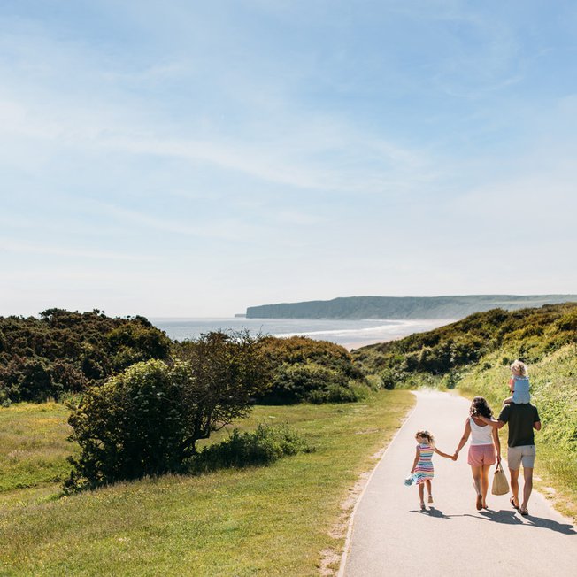 
                A young family walking to the beach, a stones throw away from our stunning Yorkshire resort, The Bay Filey.
                