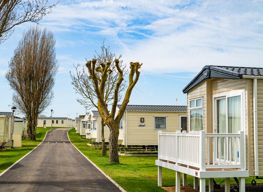 A row of caravans at our park in Essex, Mersea Island on a sunny, cloudy day.