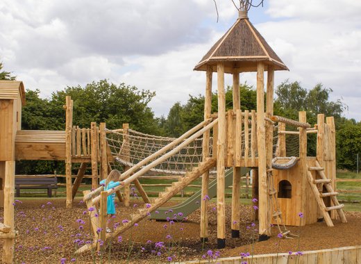 A child playing in the outdoor play area at our holiday park in Lincolnshire, Appletree.