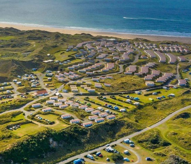 Our St Ives Bay holiday park. There are plenty of amazing holiday homes onsite, with a sandy beach running alongside, that meets the sea. There is also plenty of green space surrounding the park.