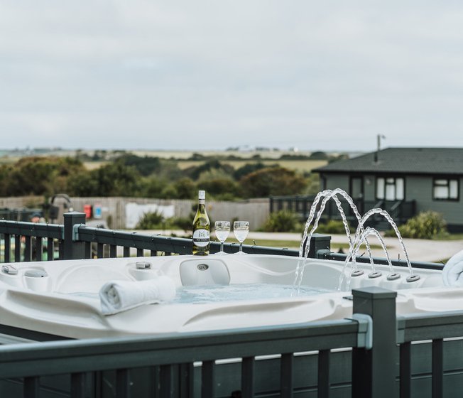 One of our stunning accommodations with a hot tub and a bottle of bubbly, relaxation at it's finest!