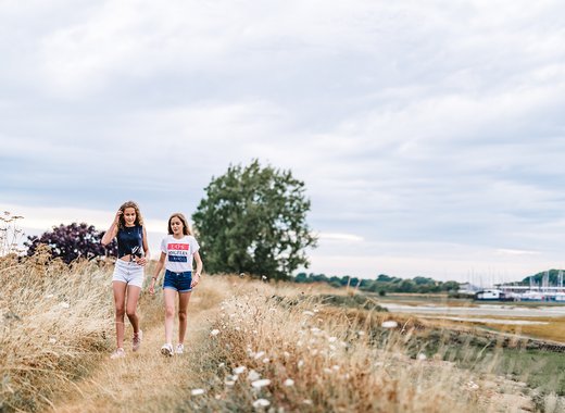 Sisters enjoying a sunny stroll by the harbour near our Mill Rythe Holiday Park in Hampshire.