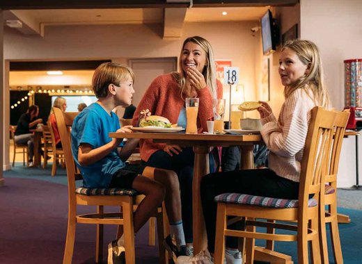 Family enjoying a bite to eat at our Newquay Bay Holiday Park.