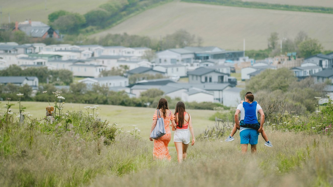 
              Family walking towards our holiday resort in Cornwall, Bude.
              