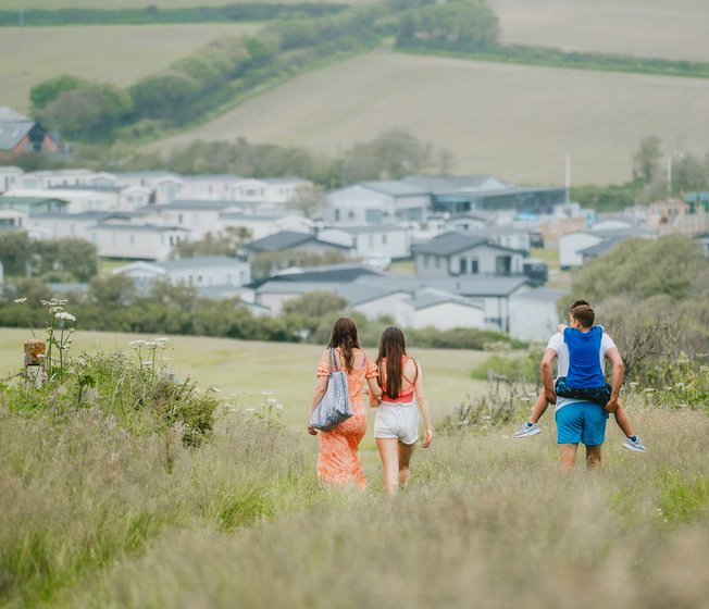 Family walking towards our holiday resort in Cornwall, Bude.